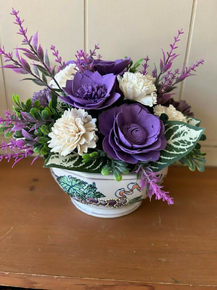 White container with purple grapes on it, green and purple filler, white and purple Sola Wood Flowers.